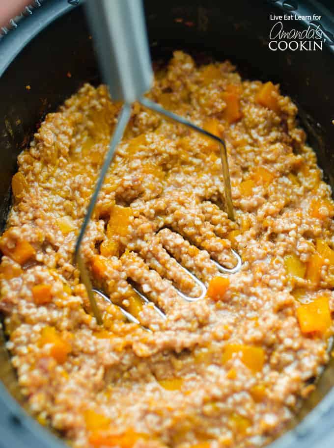 Mashing the butternut squash oatmeal in crockpot
