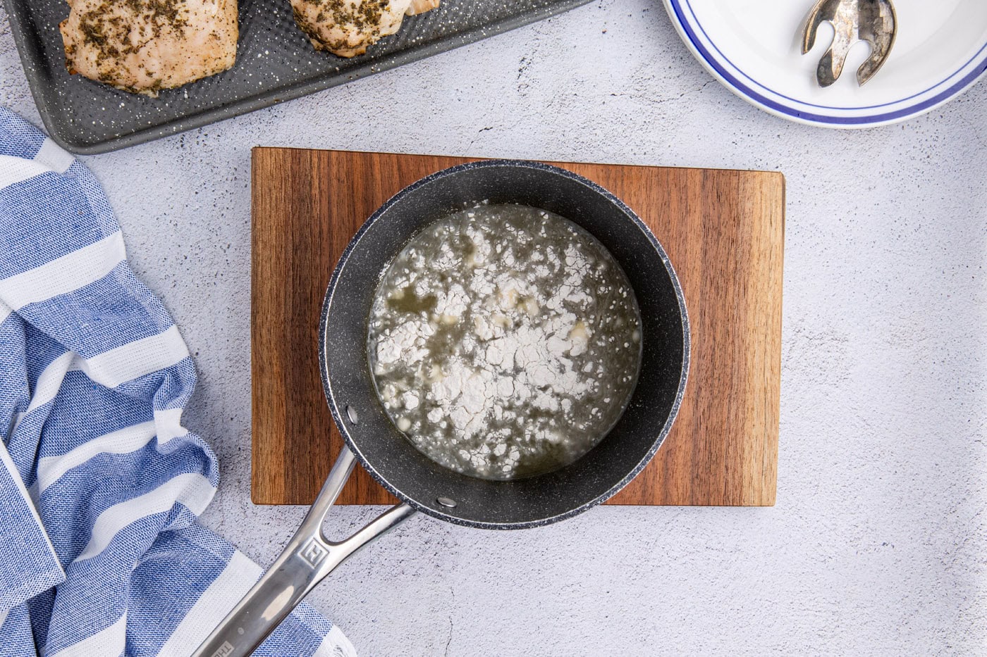 adding flour to chicken stock and apple cider mixture