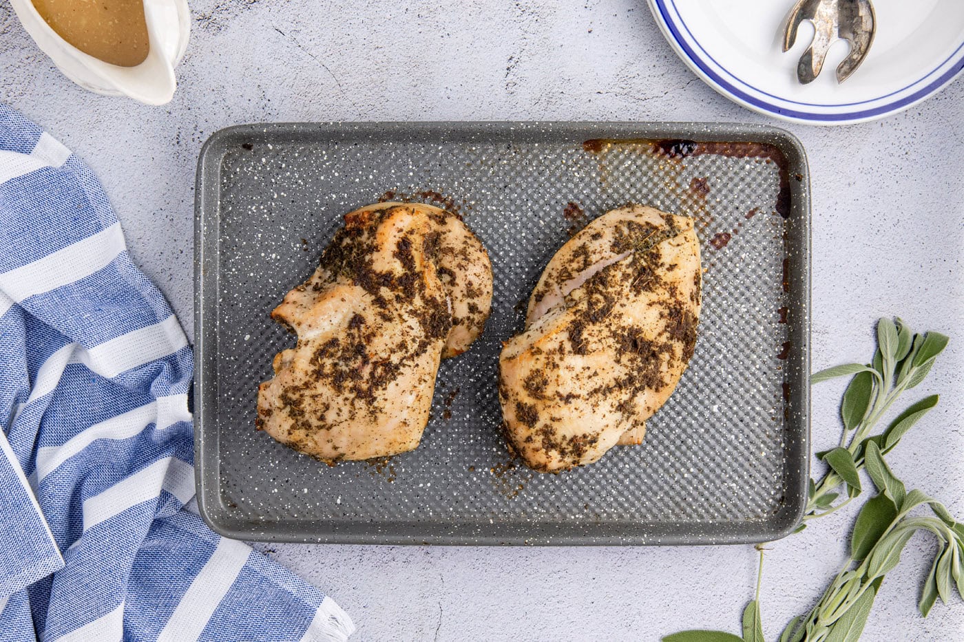turkey breasts resting on a baking sheet