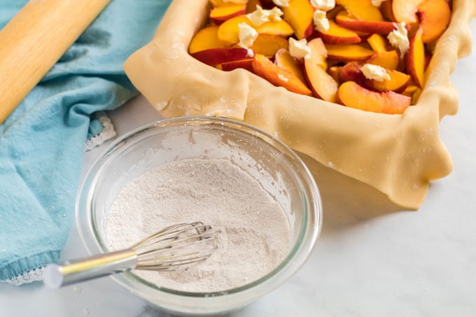 sugar mixture in bowl with pie in background