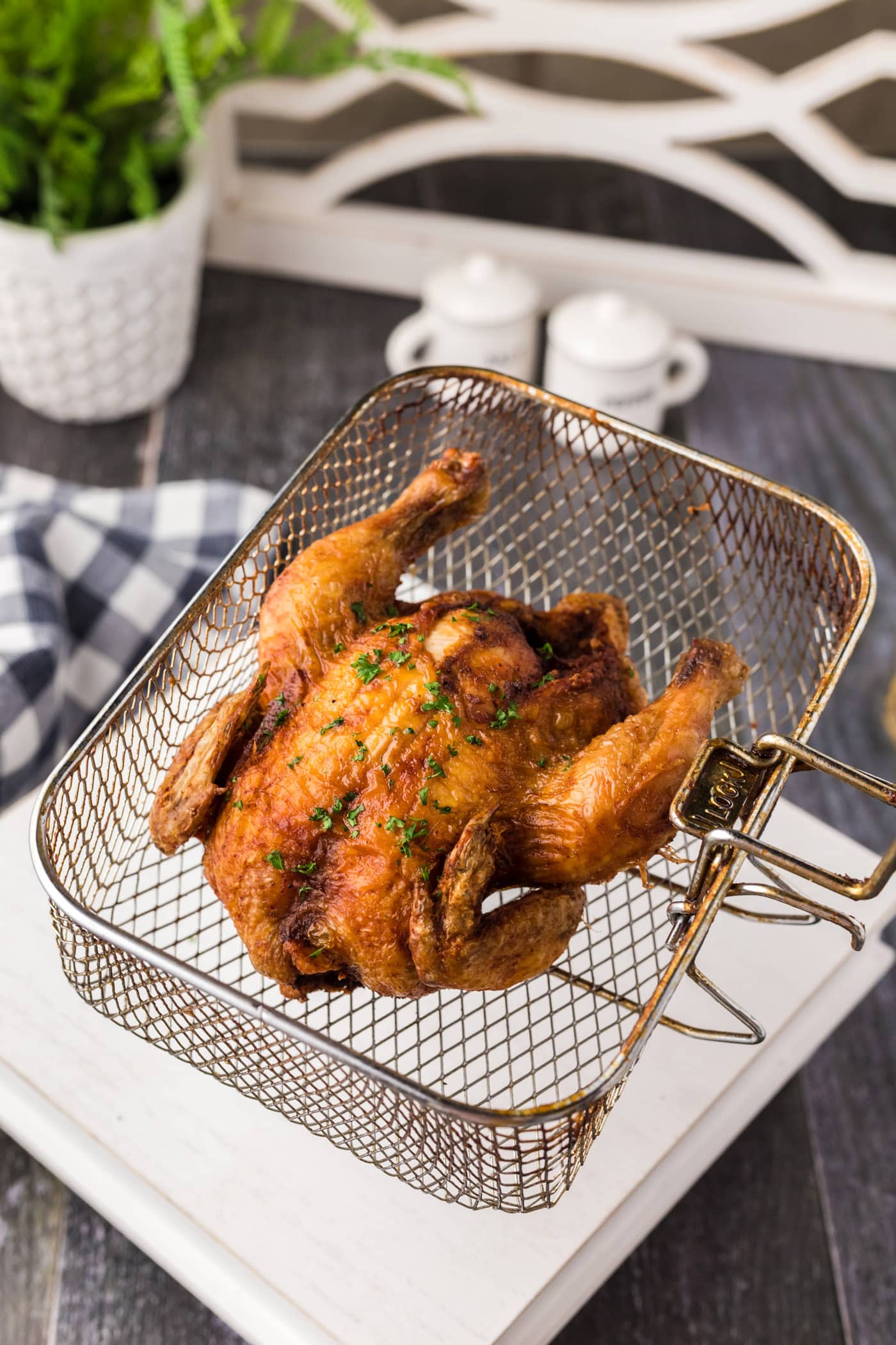 Deep Fried Cornish Hen in a deep fryer basket
