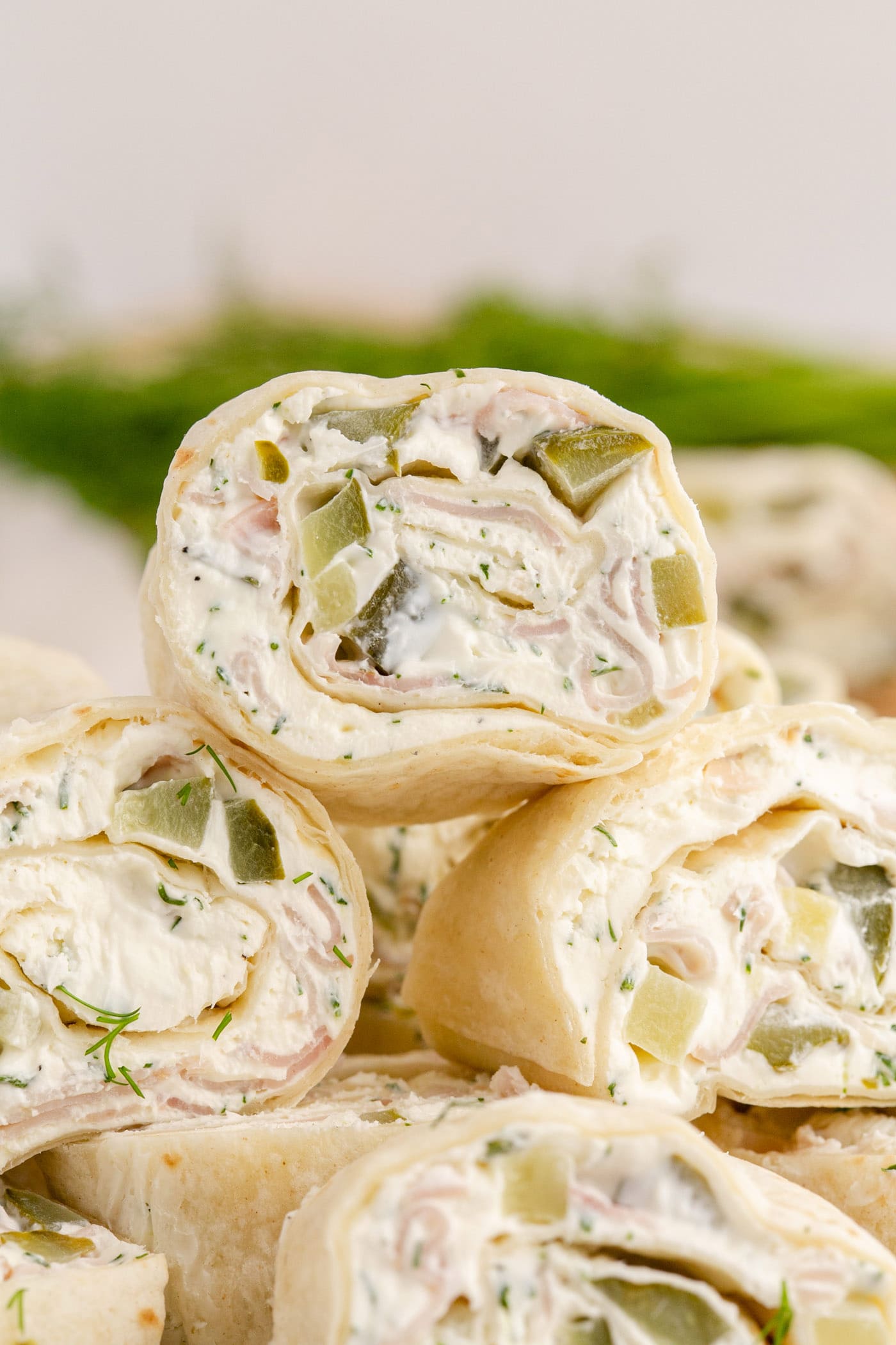 Close up photo of Dill Pickle Pinwheels stacked on top of each other