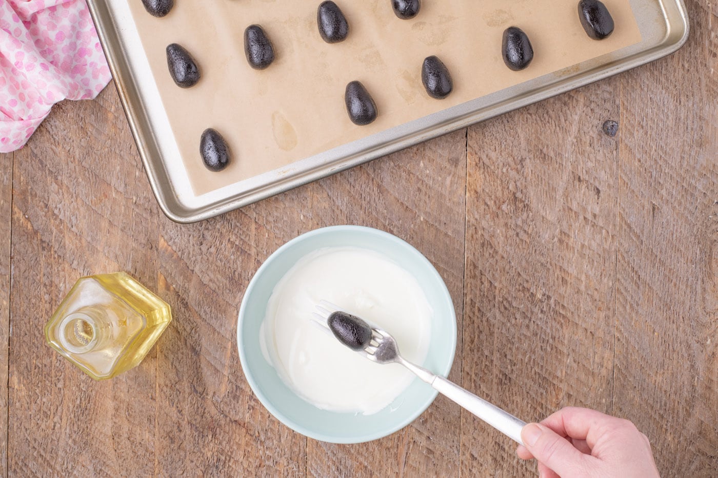 dipping Easter egg Oreo truffles in white chocolate