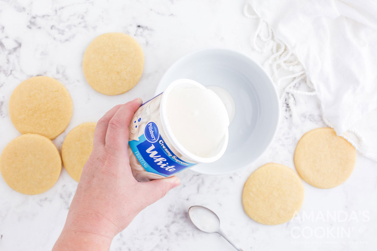 pouring frosting in bowl