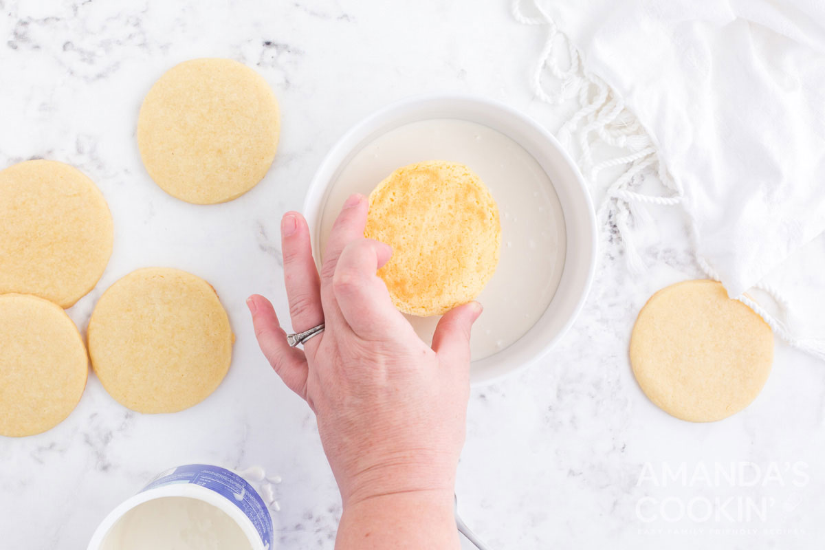 dipping cookie in icing
