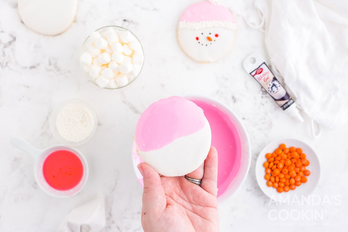 a cookie iced with white and pink