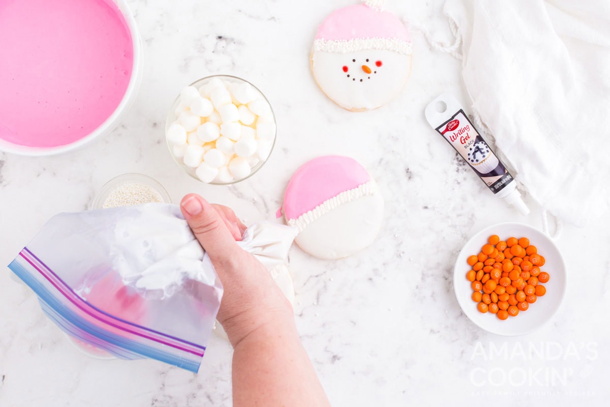 piping icing onto cookie