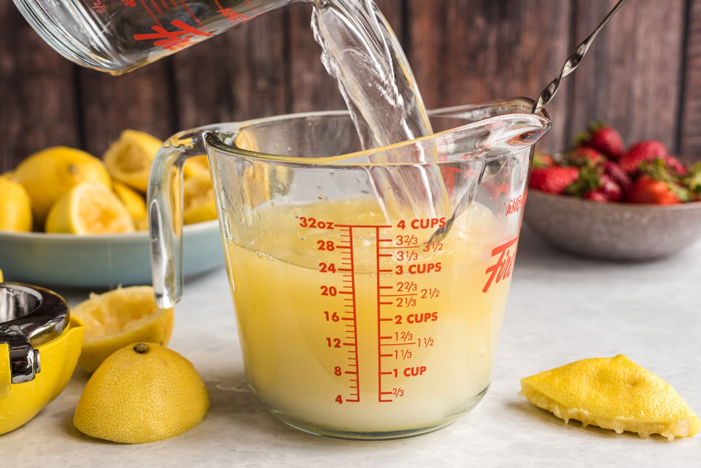 pouring boiling water into lemon juice