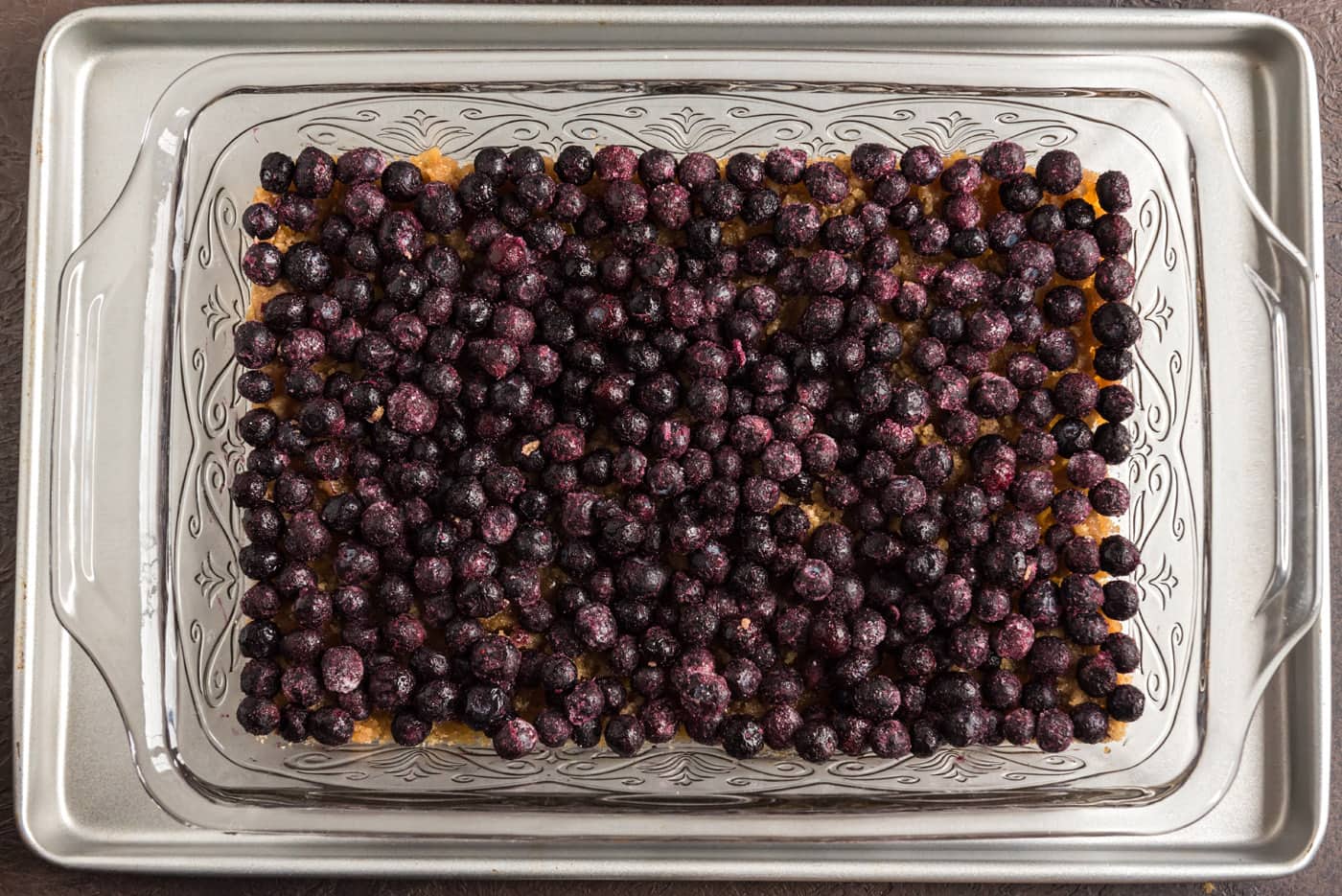 blueberries added on top of brown sugar and butter mixture