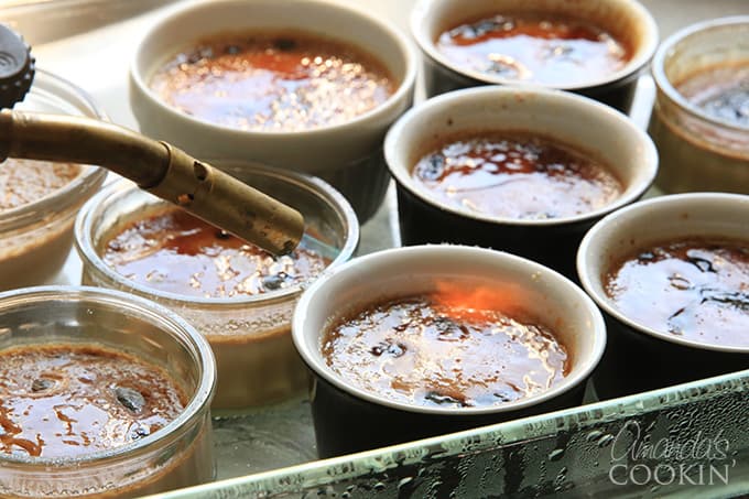 Browning the espresso creme brulees with a kitchen torch