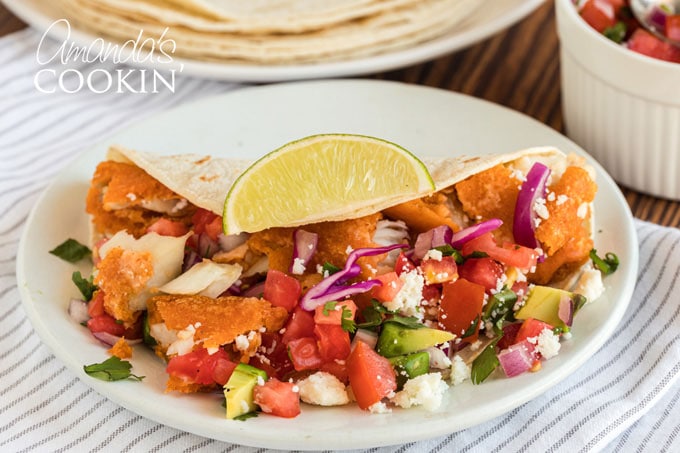 fish taco with toppings on plate