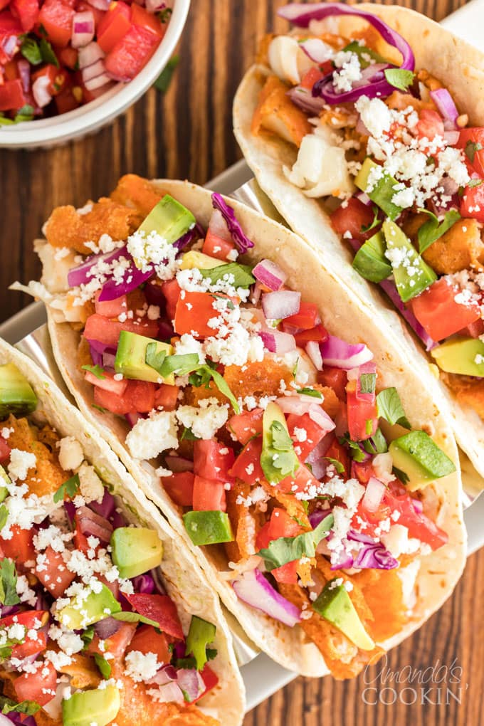 overhead view of fish tacos with toppings