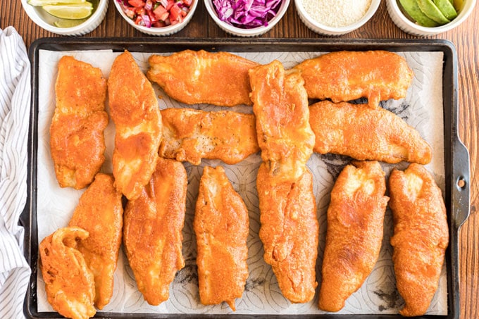 fried fish draining on paper towels