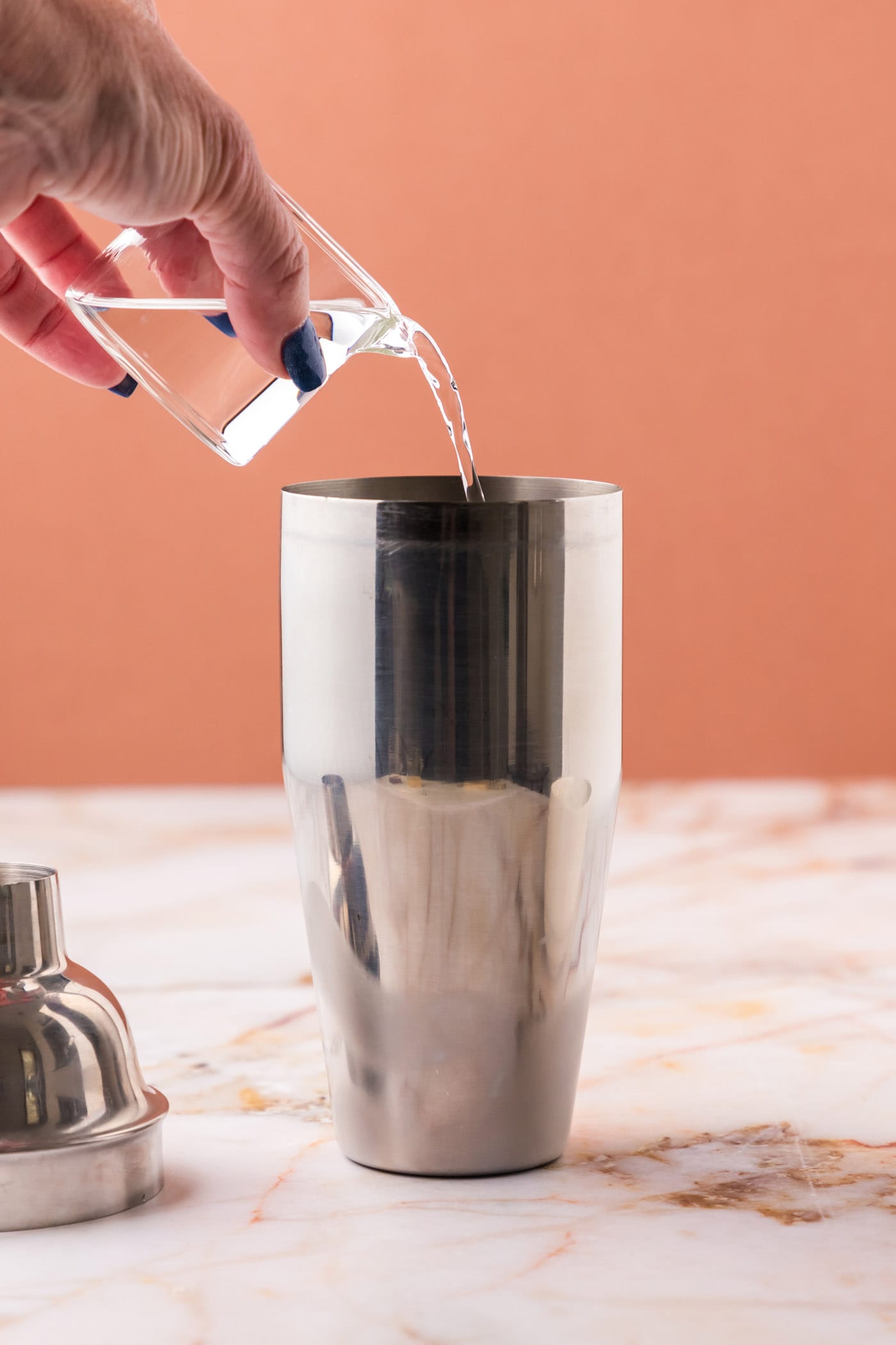 pouring vodka into cocktail shaker