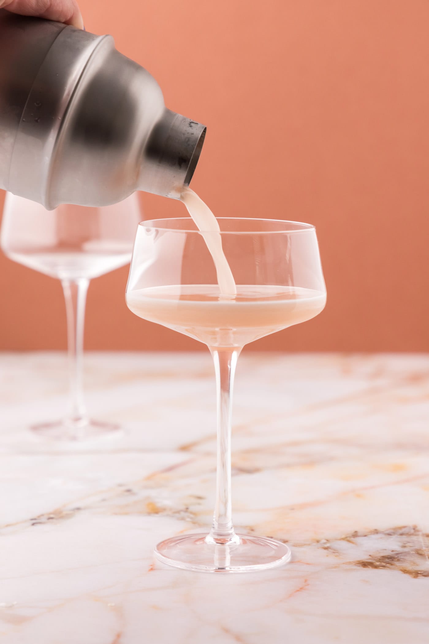 straining french martini into a glass