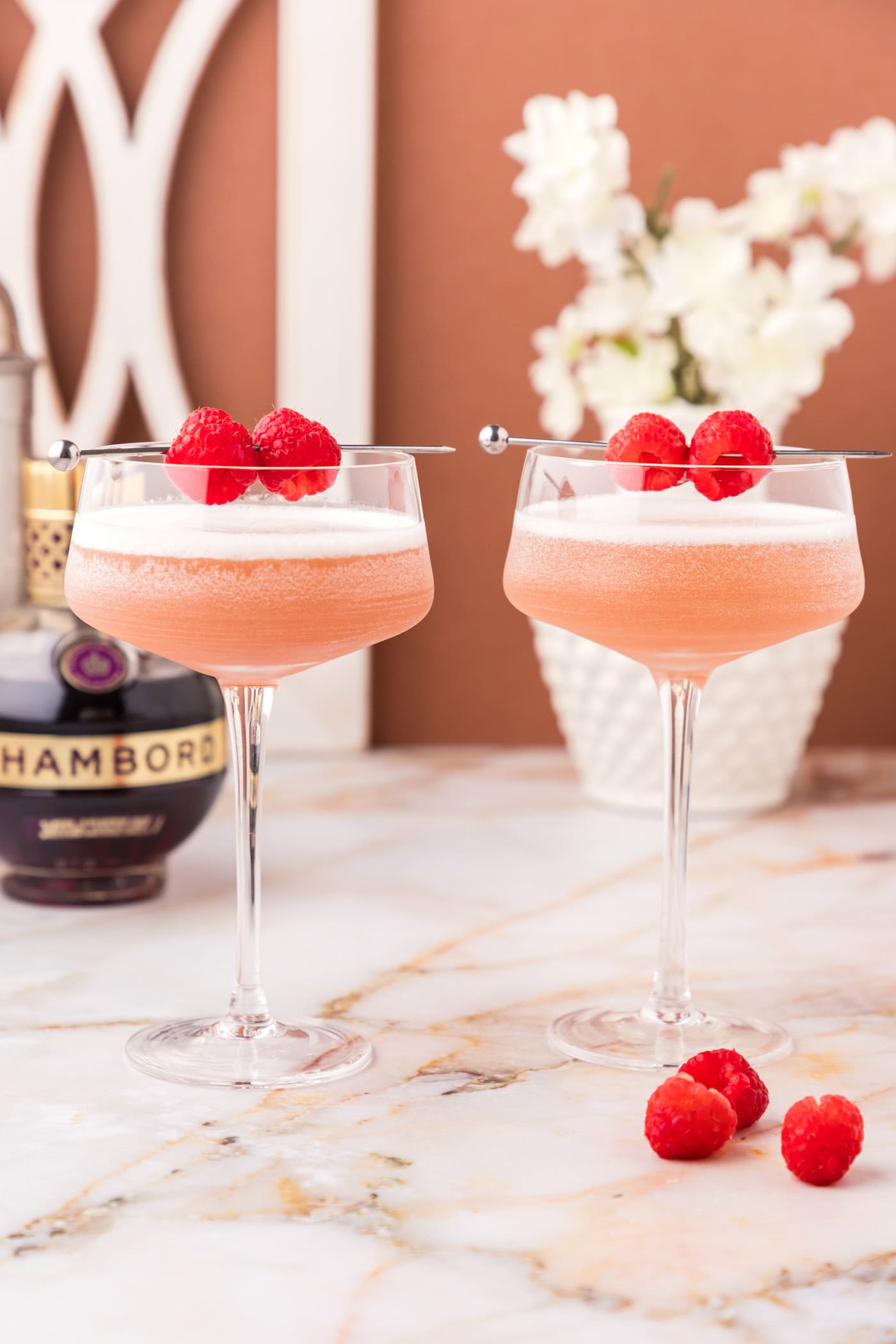 Two French Martinis topped with two raspberries