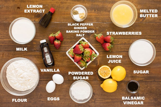 labeled ingredients for fresh strawberry muffins: flour, sugar, eggs, butter, black pepper, baking powder, ginger, salt, balsamic vinegar, strawberries, lemons, vanilla and lemon extract, powdered sugar, milk