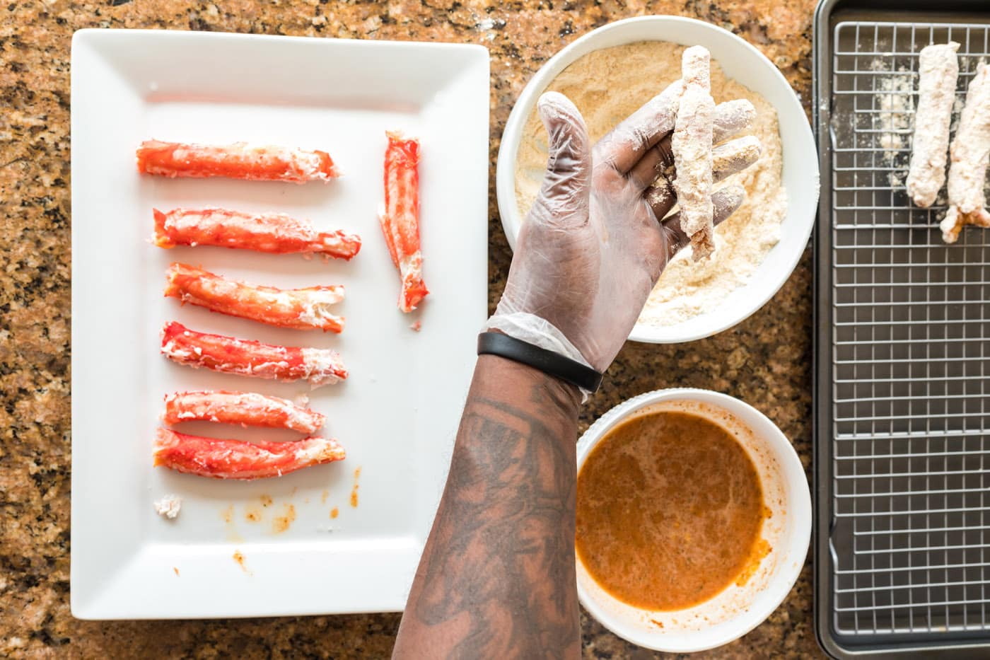 dipping crab legs into flour mixture