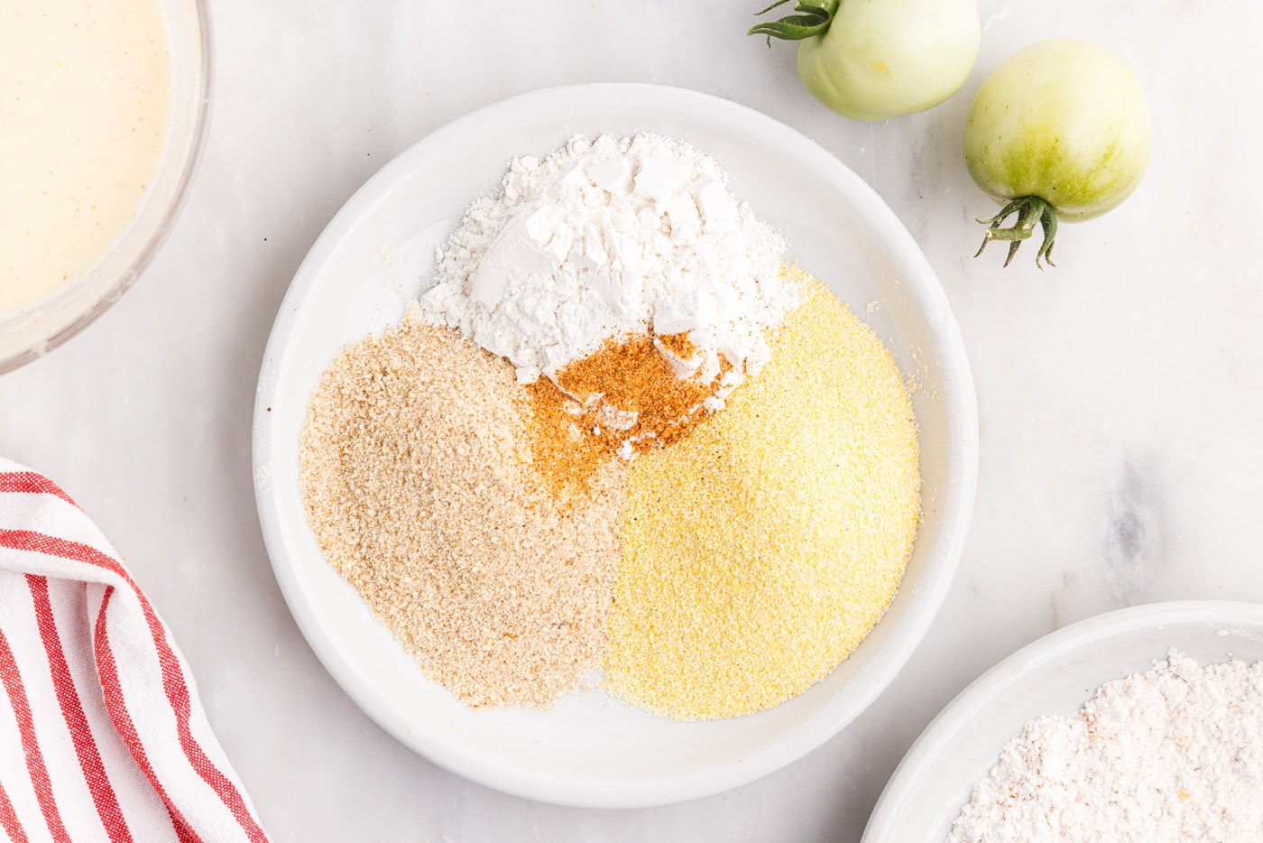 flour, cornmeal, cajun seasoning, and breadcrumbs for fried tomatoes