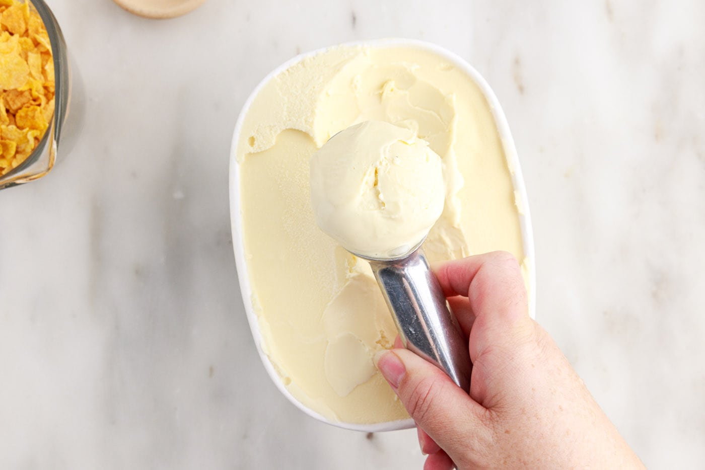 hand rolling ice cream with a scoop
