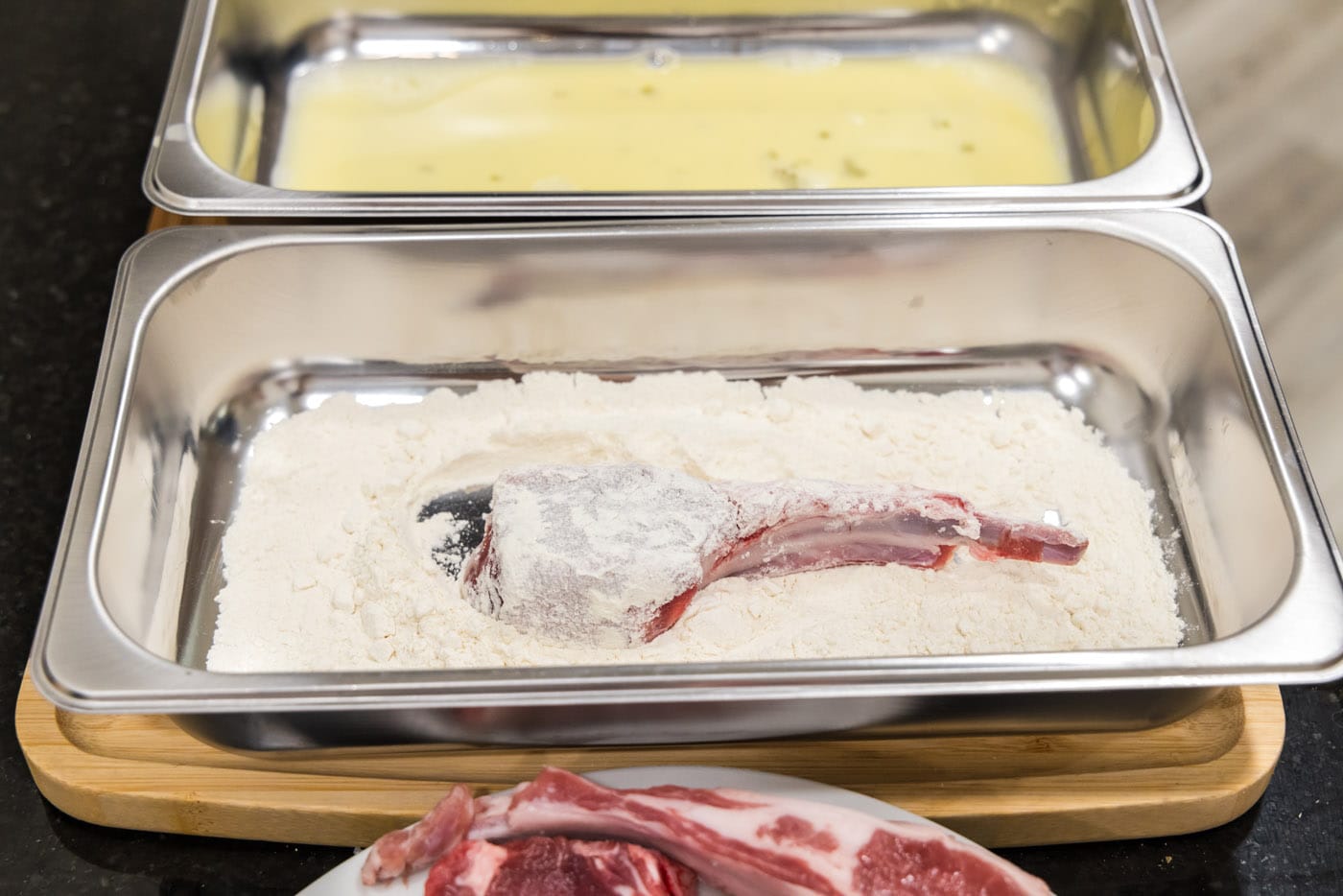 dredging lamb chop in flour