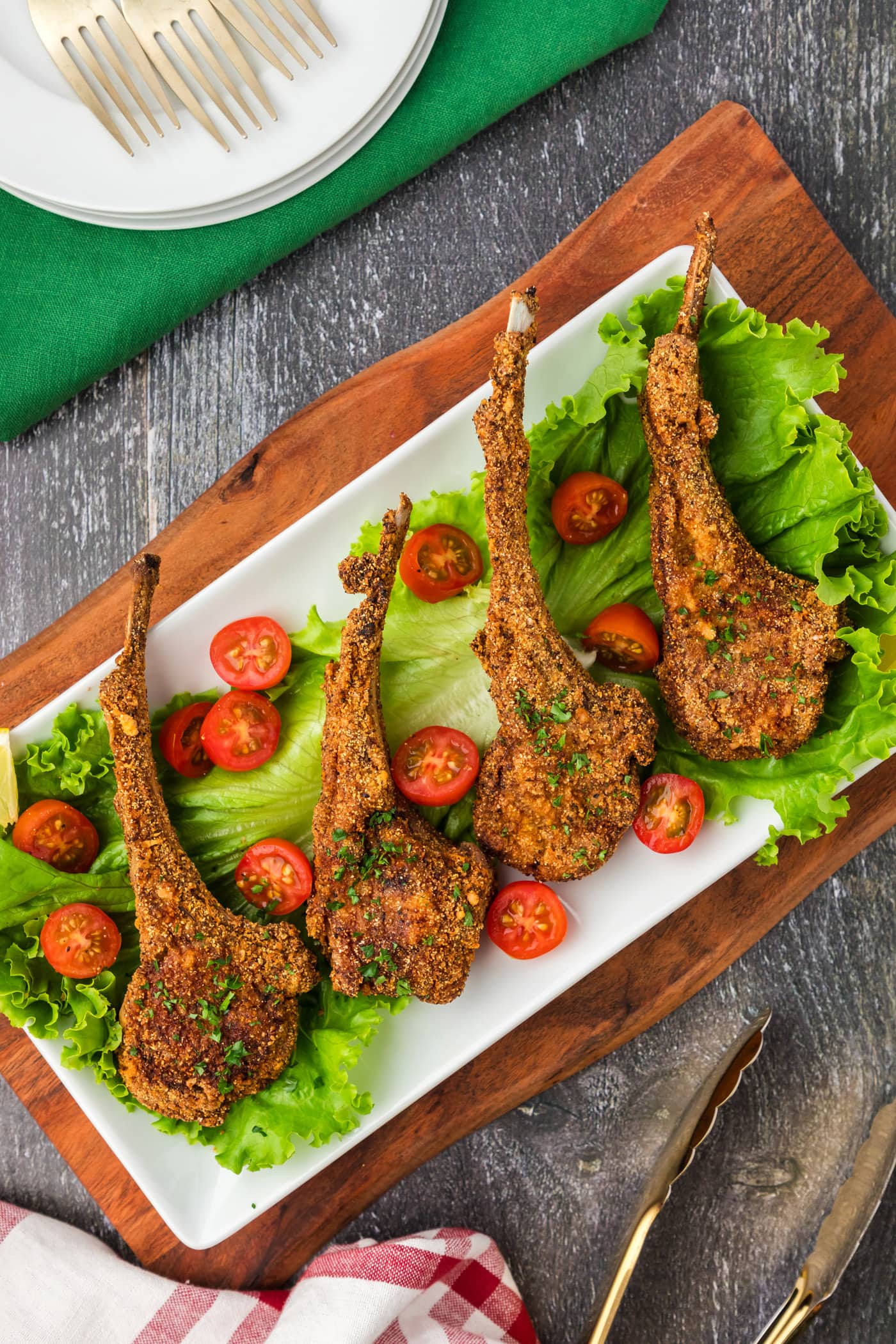 Fried Lamb Chops plated on a bed of lettuce