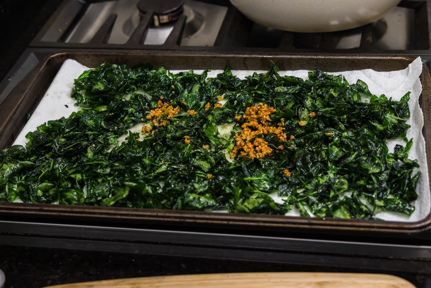 garlic on top of fried spinach