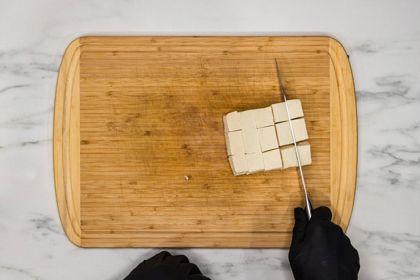 slicing tofu into cubes