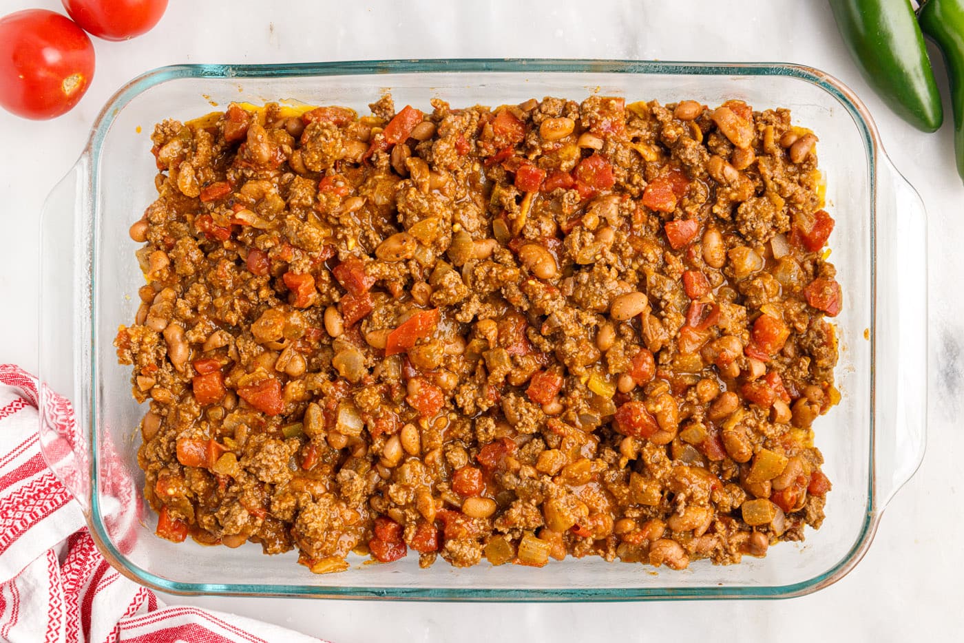 meat mixture on top of fritos and cheese in a dish