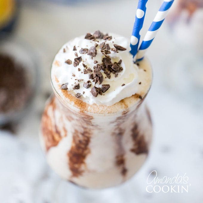 frozen mudslide cocktail in a hurricane glass with straw