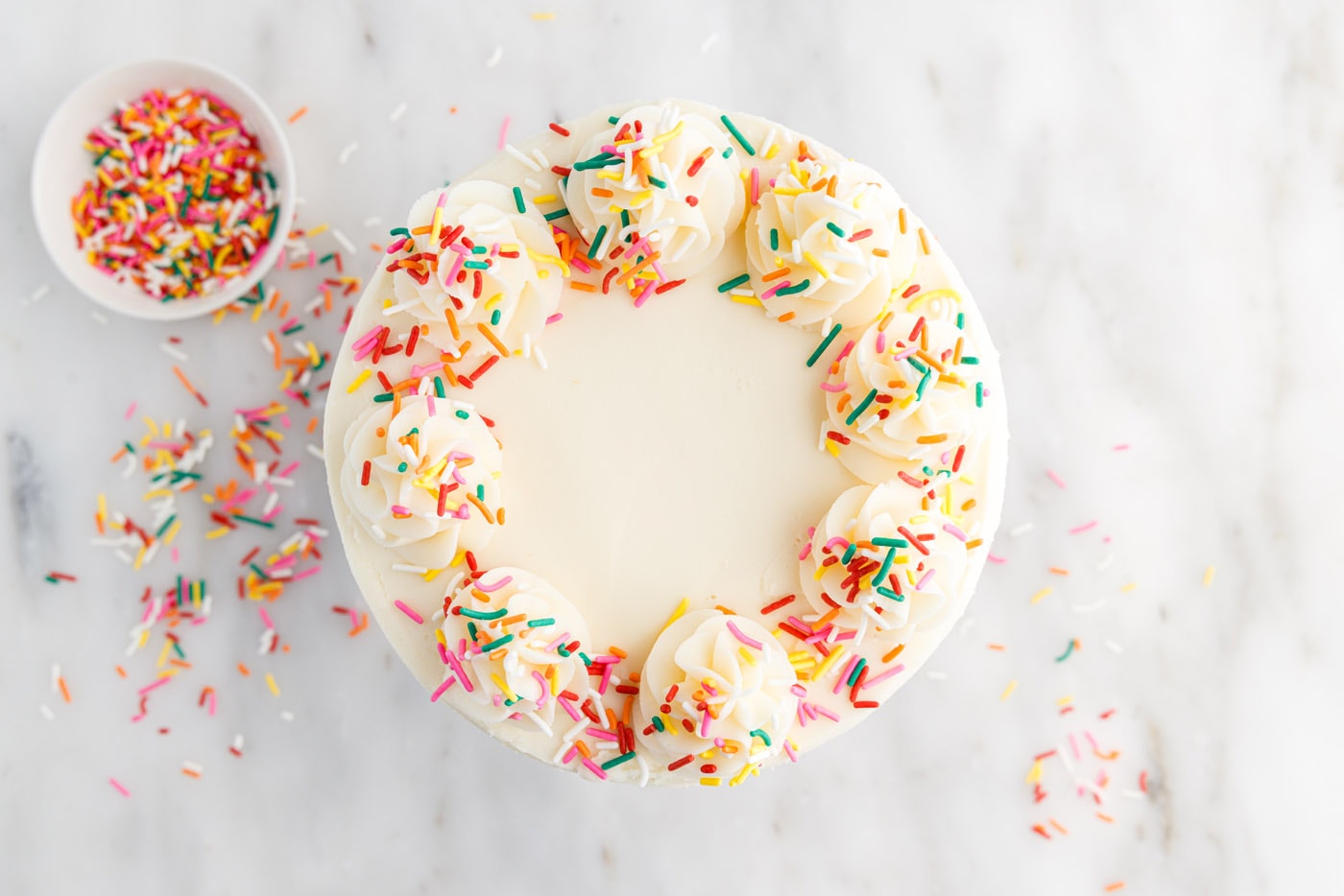 funfetti cake with piped frosting and sprinkles