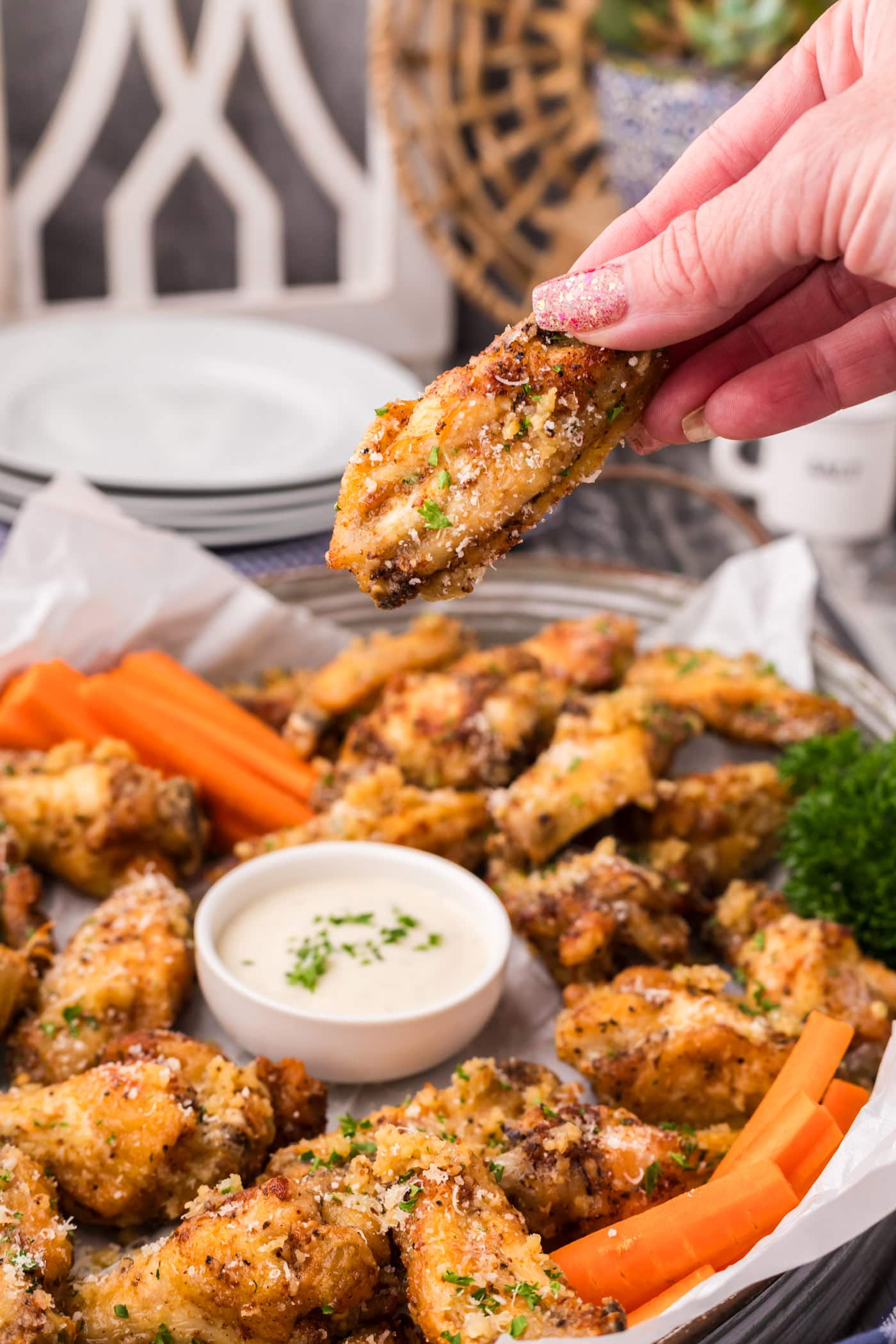 Hand holding up a Garlic Parmesan Wing