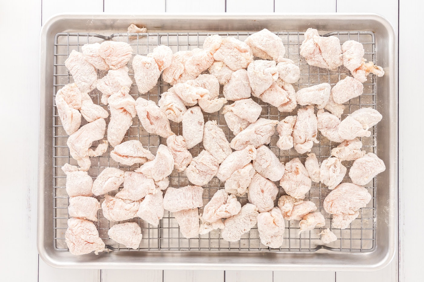 flour chicken on a wire rack