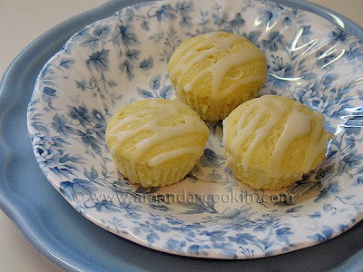 A close up photo of three German mini lemon cakes in a blue and white dish.