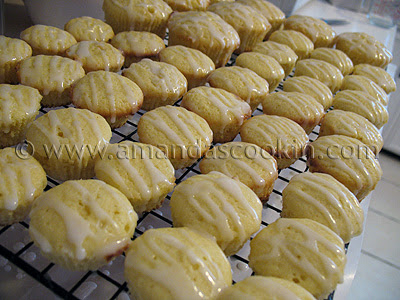 A close up photo of lots of German mini lemon cakes resting on a cooling rack.
