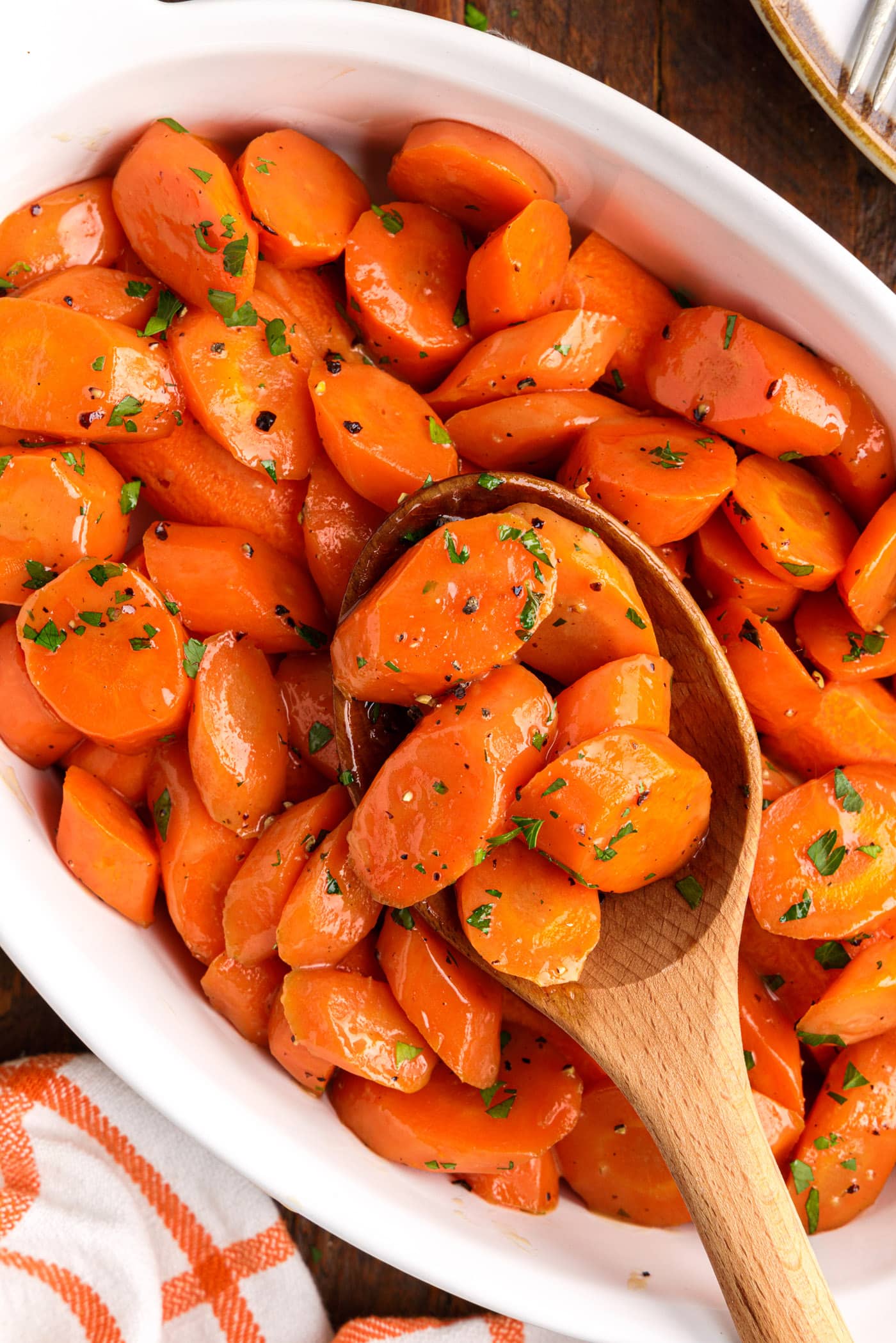 wooden spoon lifting Glazed Carrots