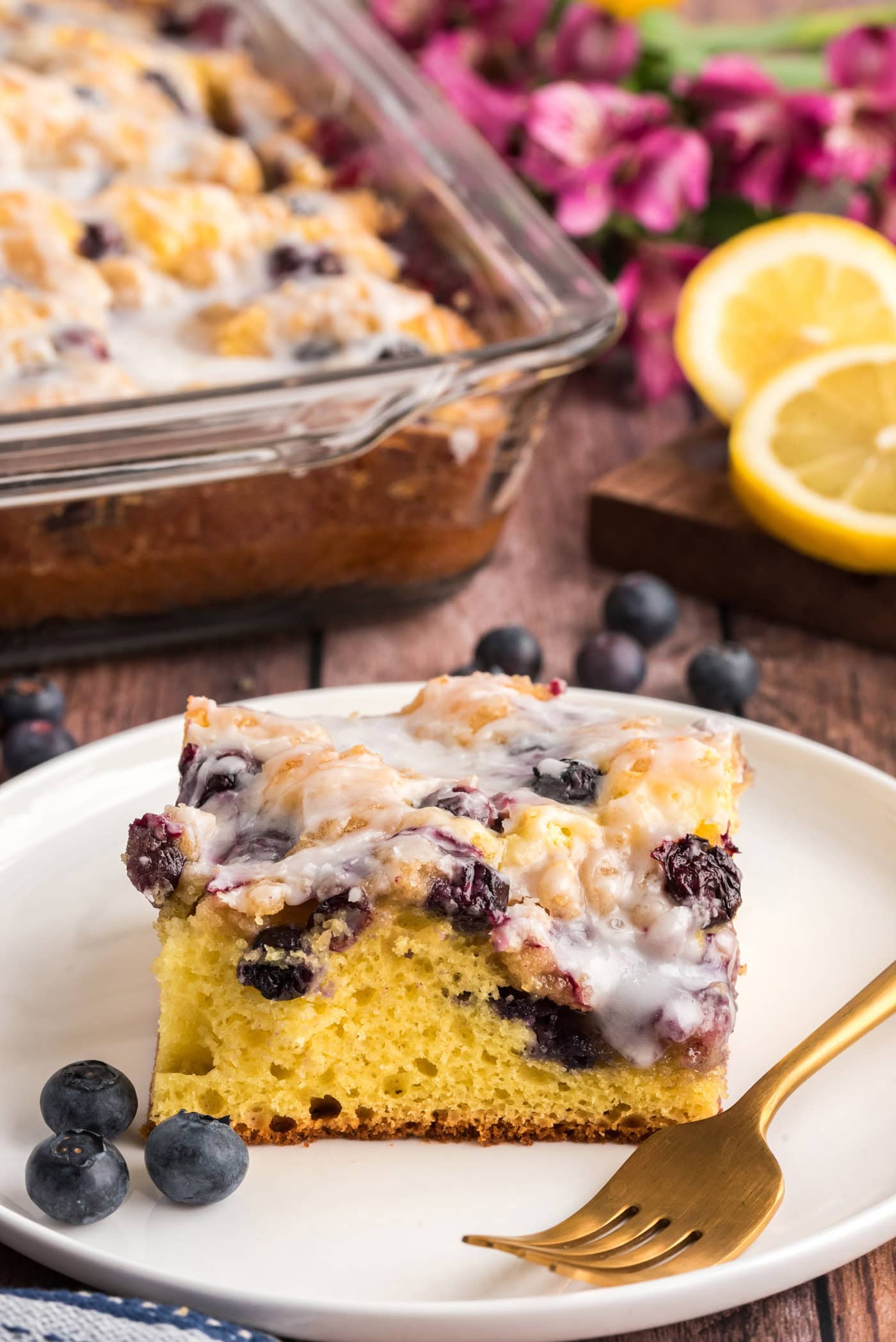 Slice of Glazed Lemon Blueberry Cake on a plate