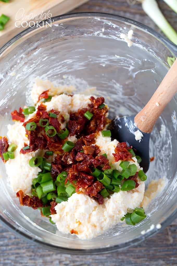 bowl of cream cheese with chives and sun dried tomatoes