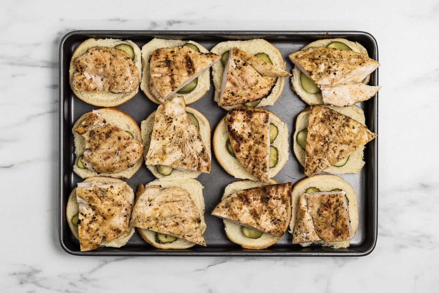 cooked chicken on top of sliders buns