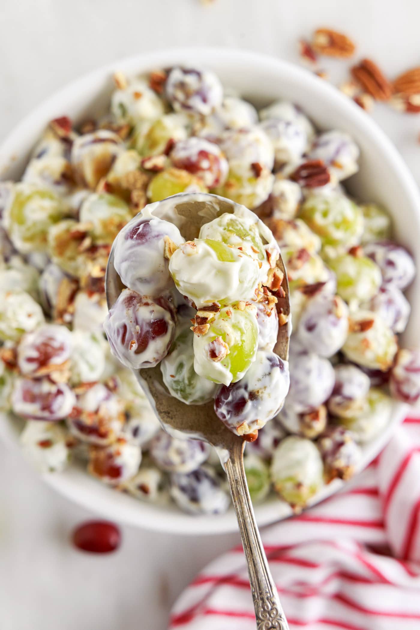 spoon of Grape Salad mover a bowl