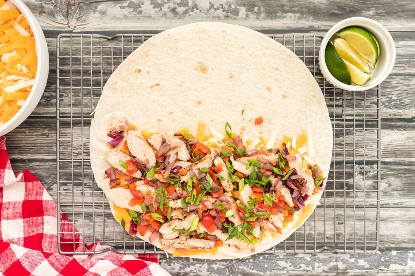 chicken, bell peppers, and onions over cheese quesadilla