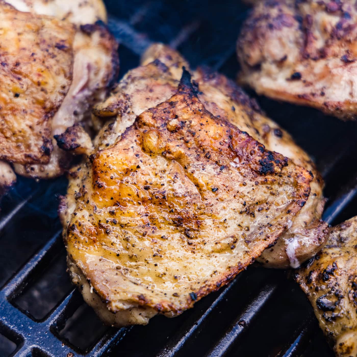 close up of chicken thighs on the grill