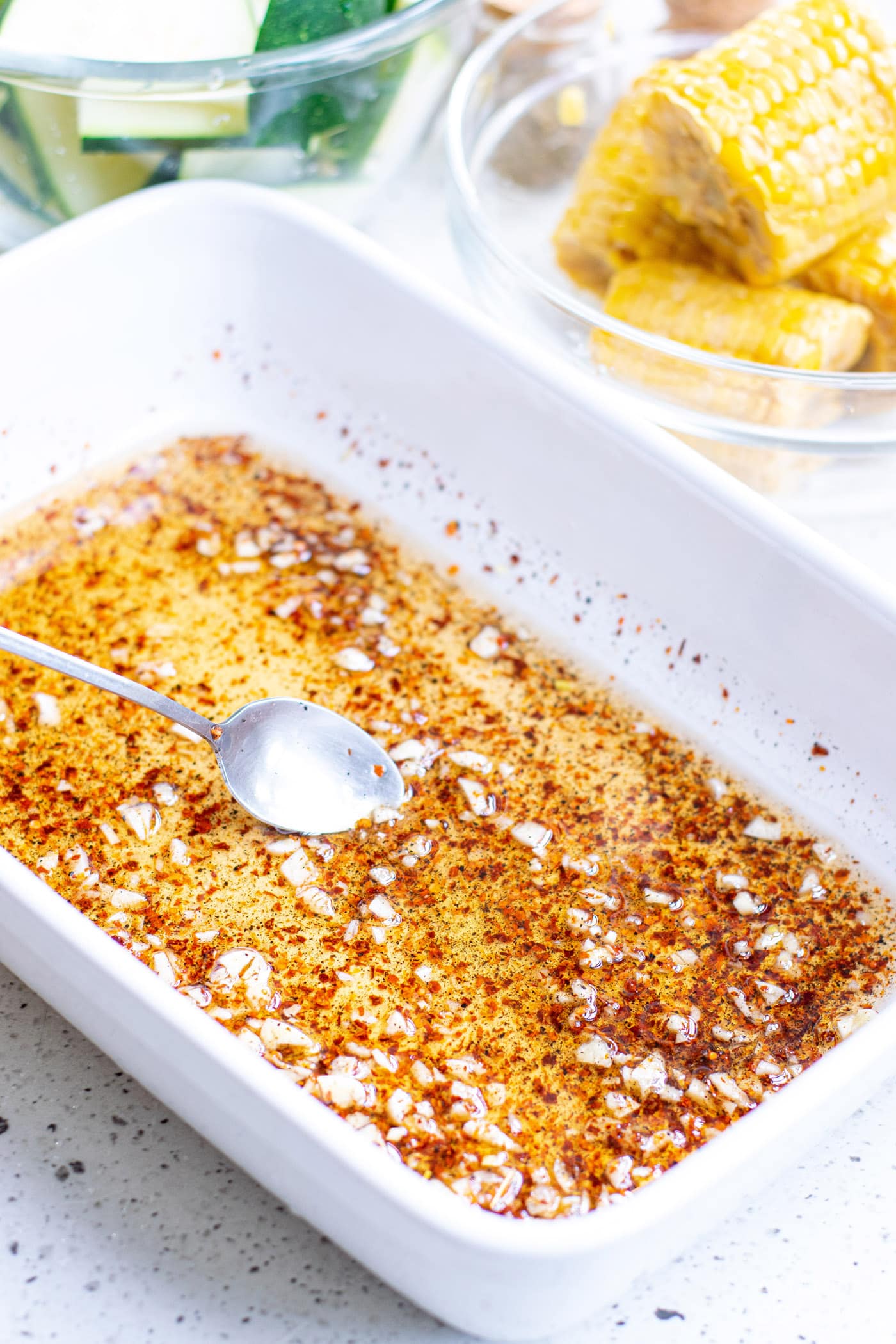 olive oil with salt and pepper and garlic in a baking dish