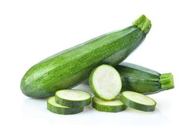 fresh green zucchini with slice isolated on white background