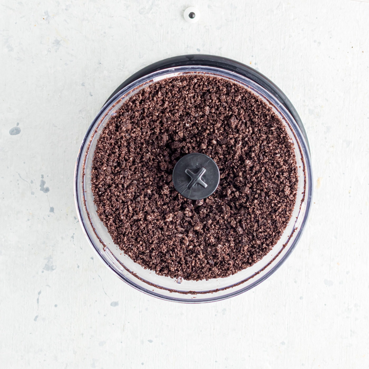 curhsed oreo cookie crumbs in a food processor