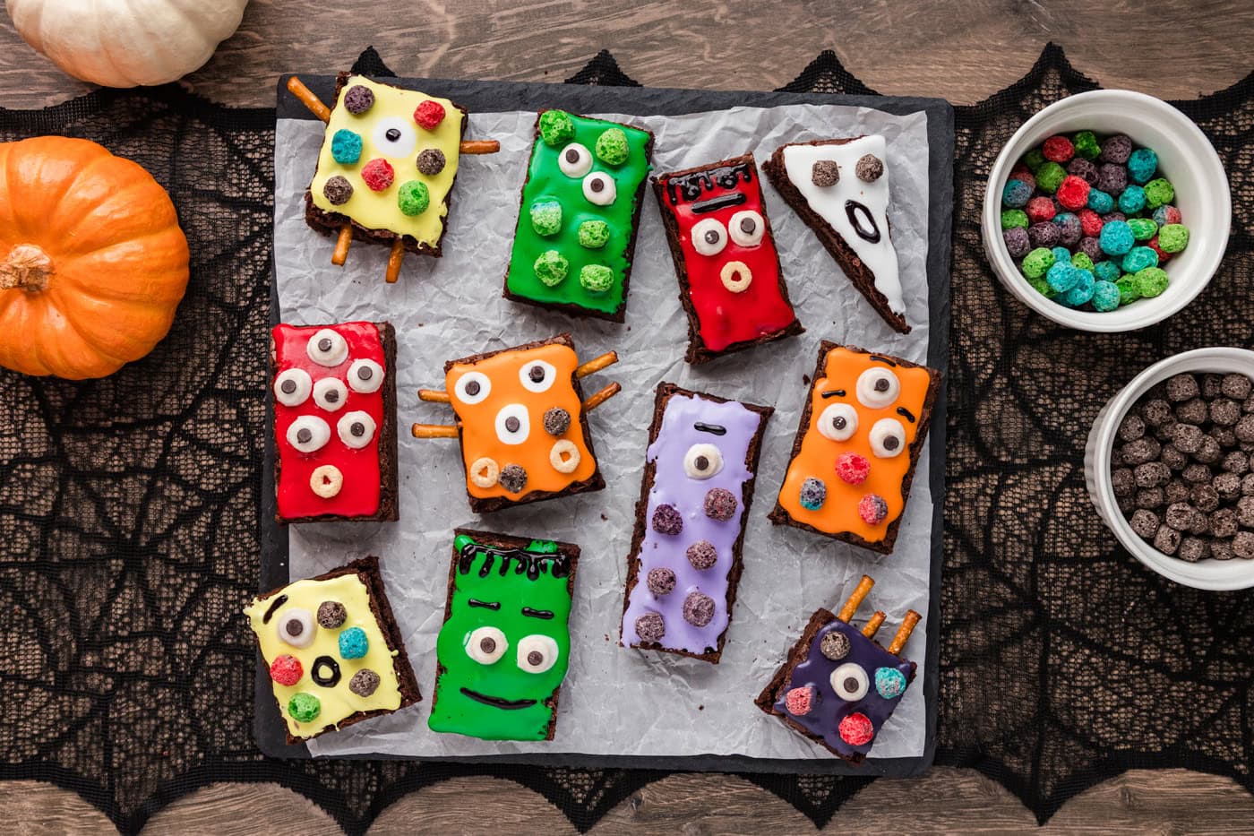 decorated monster brownies on a parchment paper sheet