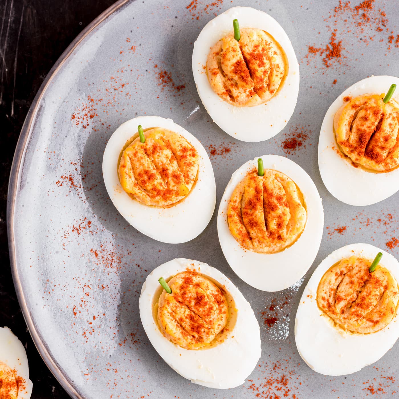 Pumpkin Deviled Eggs on a gray plate