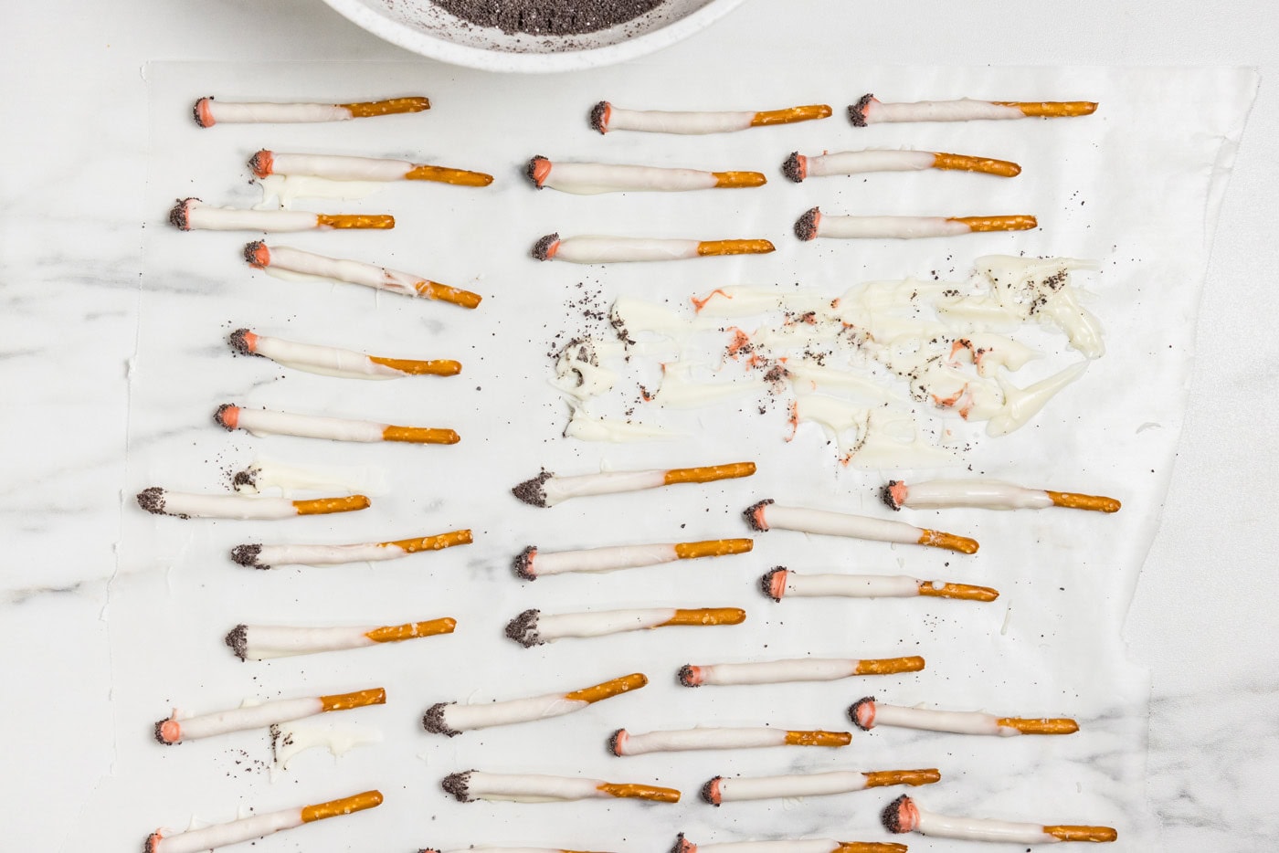 Halloween Cigarette Pretzels laying on waxed paper