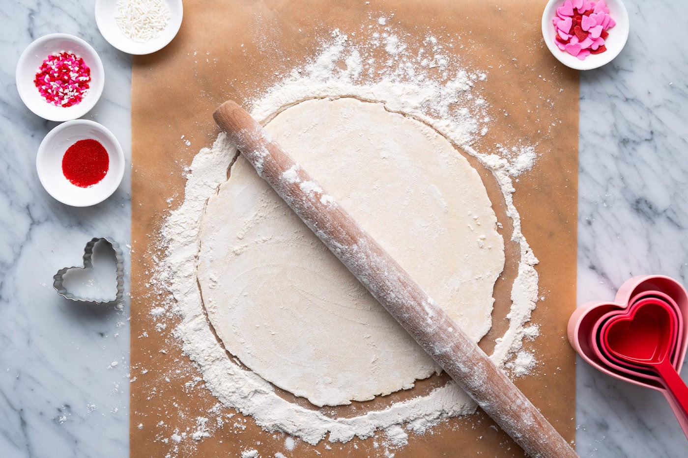 rolling pin on top of flattened pie dough