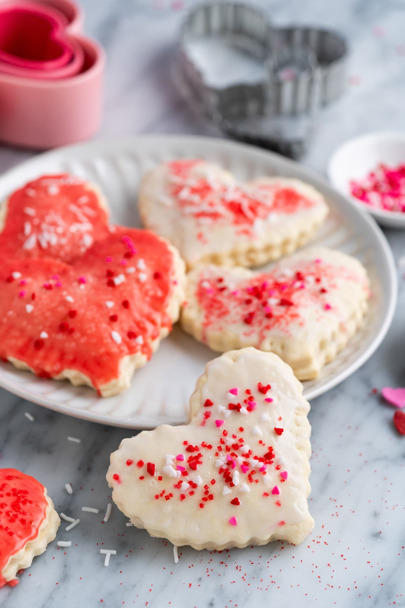 Heart Shaped Pop Tart resting on the side of a plate with more on the plate